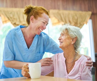 A portrait of a care home resident and an aged care nurse