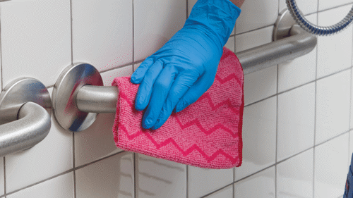 Red HYGEN™ Microfibre Cloth cleaning in bathroom