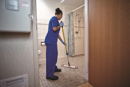 Staff cleaning bathroom floor