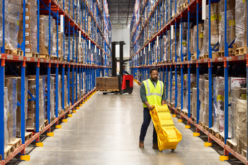 Rubbermaid mobile barrier in a folded state, being easily rolled away for compact storage and efficient mobility