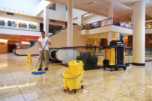 A staff cleaning hotel lobby