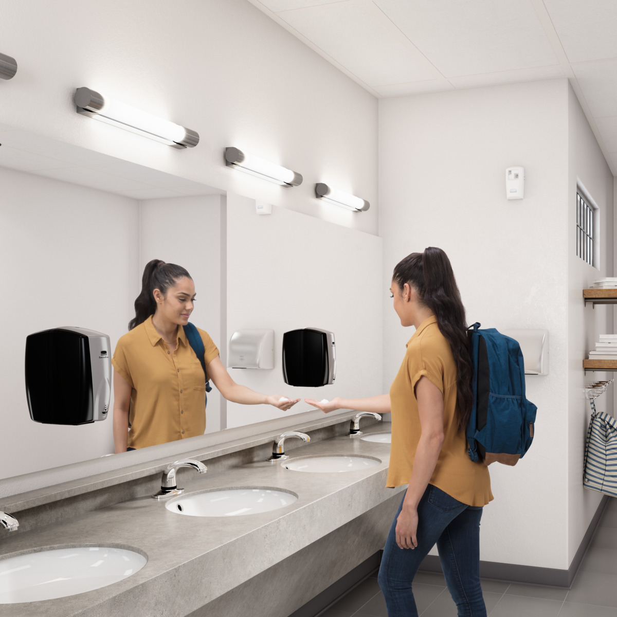 Woman getting soap from Rubbermaid AUTOFOAM DISPENSER