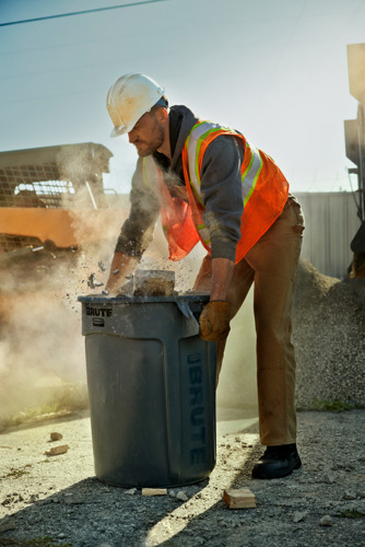 Man at construction site with brute bin