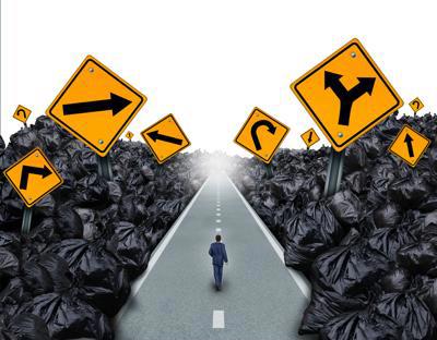 A person walking down a road surrounded by mountains of rubbish bags and arrows signalling in several directions