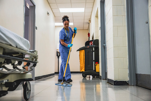 woman cleaning with a mop in a hospital