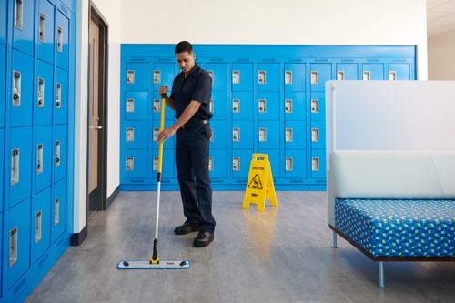 Person cleaning locker room with Hygen Microfibre mops