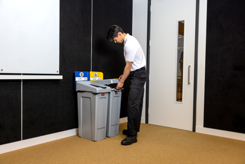 Man opening Slim Jim Recycling Station lid