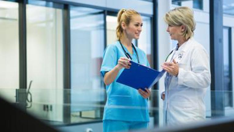 Nurse and Doctor Having Conversation