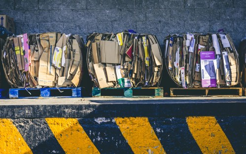 Compressed cardboard waste on wooden pallets