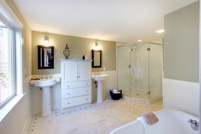 A clean hotel bathroom with a bath and a spotless glass shower door