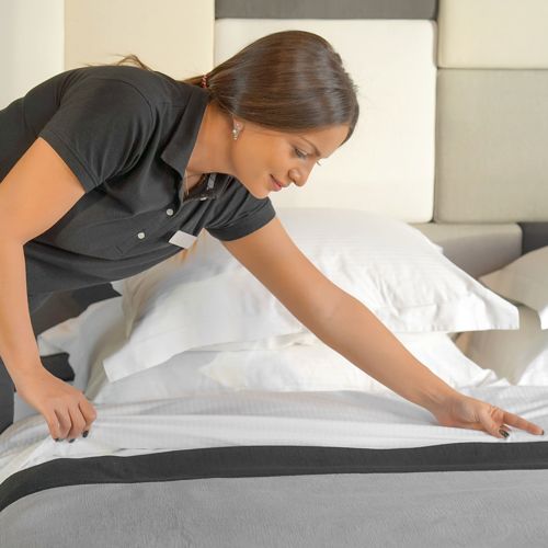 Housekeeping staff making a bed