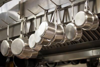 Clean pots and plans in a restaurant kitchen