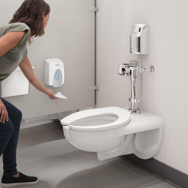 Woman using clean seat dispenser